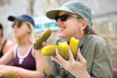 Jamea Lundy, of Supply, holds fistfuls of pickles during the pickle eating contest at the North Carolina Pickle Festival in Mount Olive on Saturday, April 13, 2019. The town is home to the Mt. Olive Pickle Company which opened there over 90 years ago.