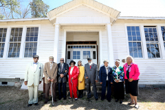 William Johnson, l, Thomas Wilder, Henry Harrington, Peggy Harrington, Helen Stephens Sneed, Irving Stephens, Pearline Fowler, Clarice Bank and Ella Perry standing infant of their former school, the Panther Branch Rosenwald School. Constructed in 1926, the Rosenwald School is one of only four extant Rosenwald School buildings in Wake County, out of twenty-one that were built from 1921 through 1926, and the only remaining example of the Three-Teacher Community School plan.  It closed in 1957, three years after Brown v. Board of Education deemed public school segregation unconstitutional.March 8, 2020. Raleigh, NC