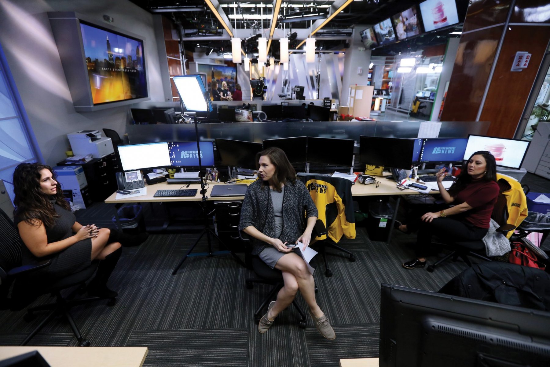 Reporter Ana Rivera, l, anchor/reporter Andrea Blanford and reporter Elaina Athans talk in the ABC11 Eyewitness newsroom. January 15, 2020. Raleigh, NC