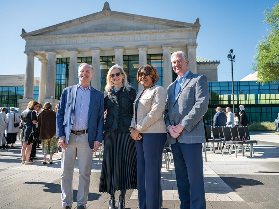 City leaders stand together in front of the performing arts center.